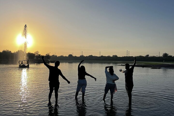 Experience the magic of Love Lake at sunset where laughter and joy blend with the stunning scenery creating unforgettable memories amidst the tranquil desert surroundings.